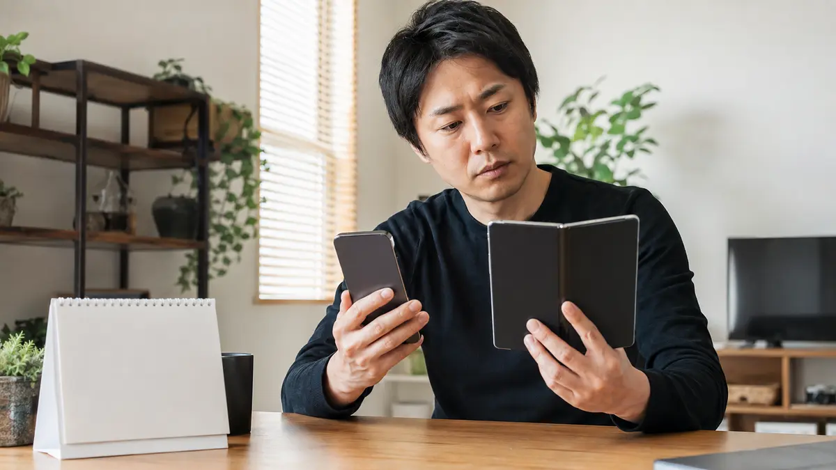 折りたたみiPhoneの発売を待つか比較する男性 折りたたみiPhoneの発売を待つべきか比較する日本人男性